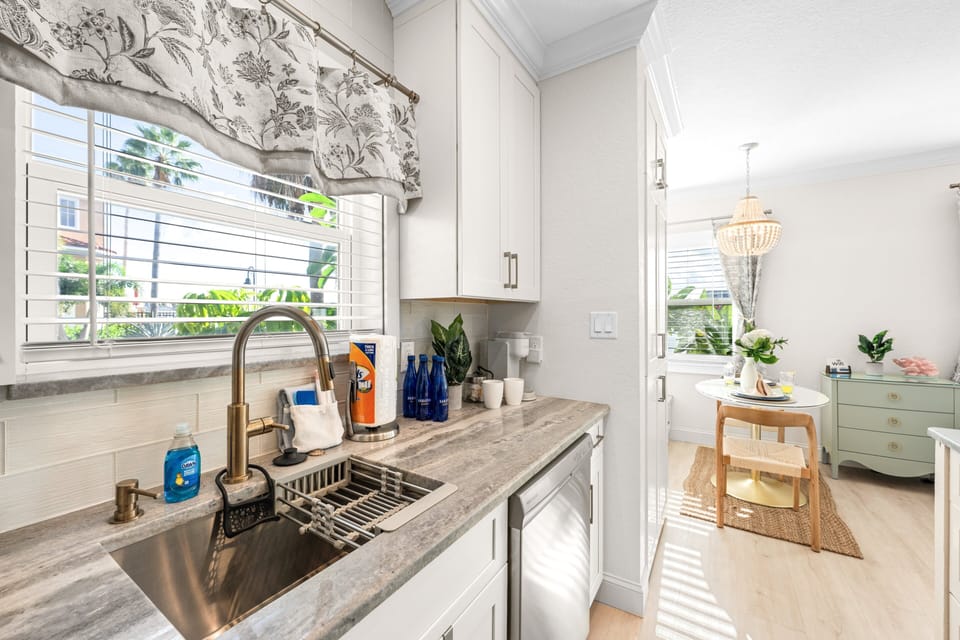 Prepare your favorite meals in the completely updated kitchen, featuring modern finishes and a bright, open layout overlooking the Intracoastal waterway.