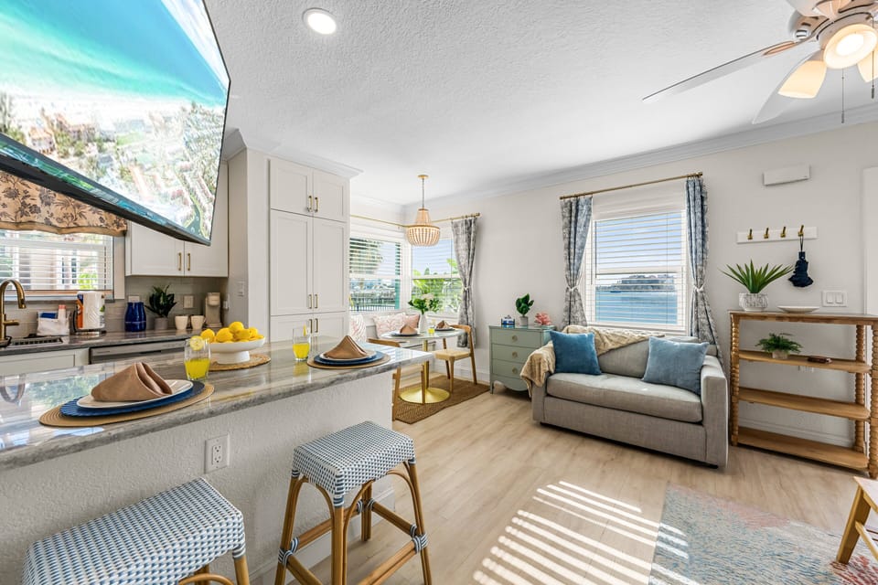 The open living and dining area creates a bright, inviting space to unwind after a day at the beach, with waterway views adding to the coastal atmosphere.