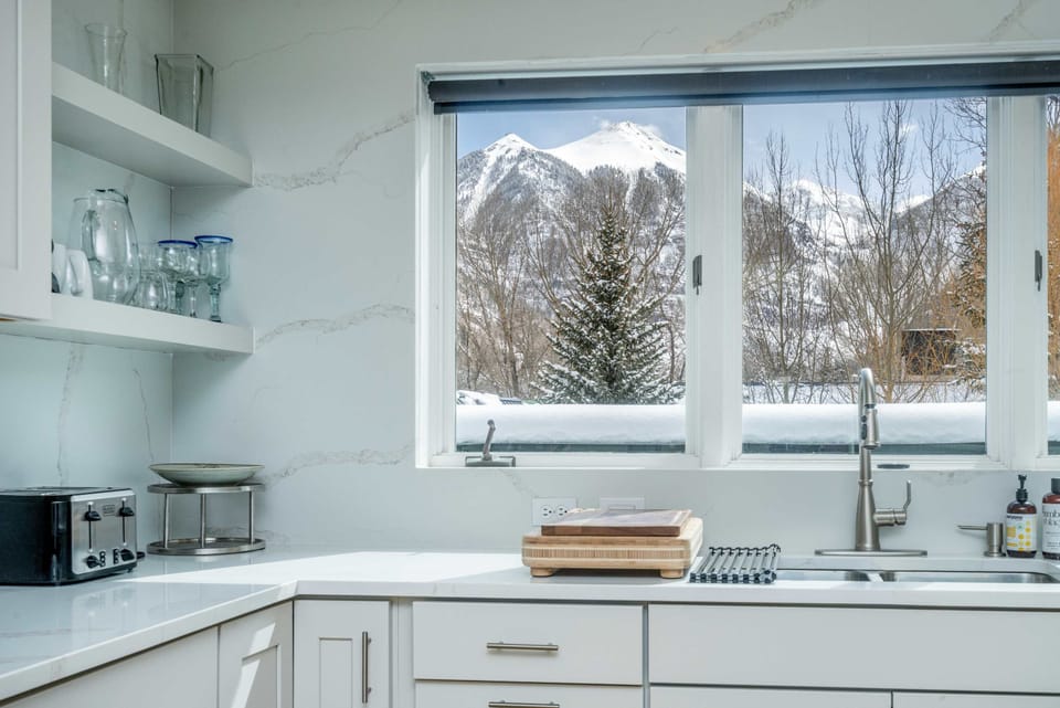 Kitchen: Main floor, drip coffee maker, toaster, blender, cooking utensils, tableware