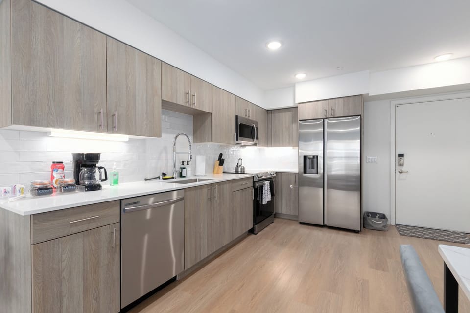 Spacious full kitchen with new Samsung appliances and quartz countertops.