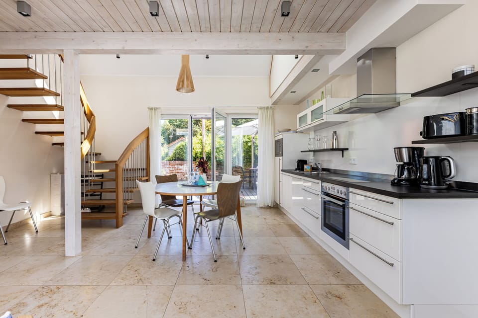 Modern kitchen with dining area and garden access