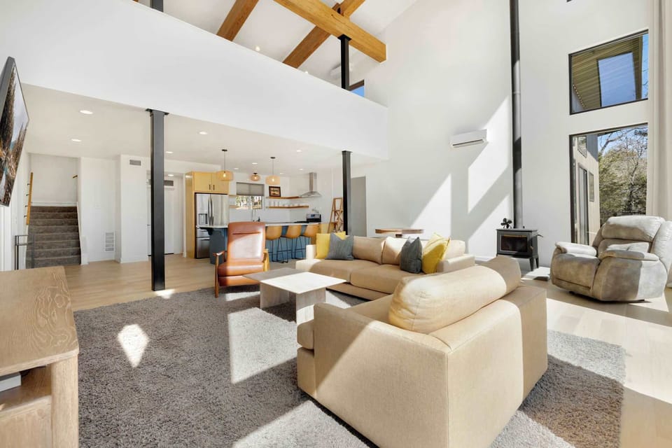 When you first enter our home, you'll be greeted by our open concept living space, dining, and kitchen area. The living room has seating and a large Smart TV.