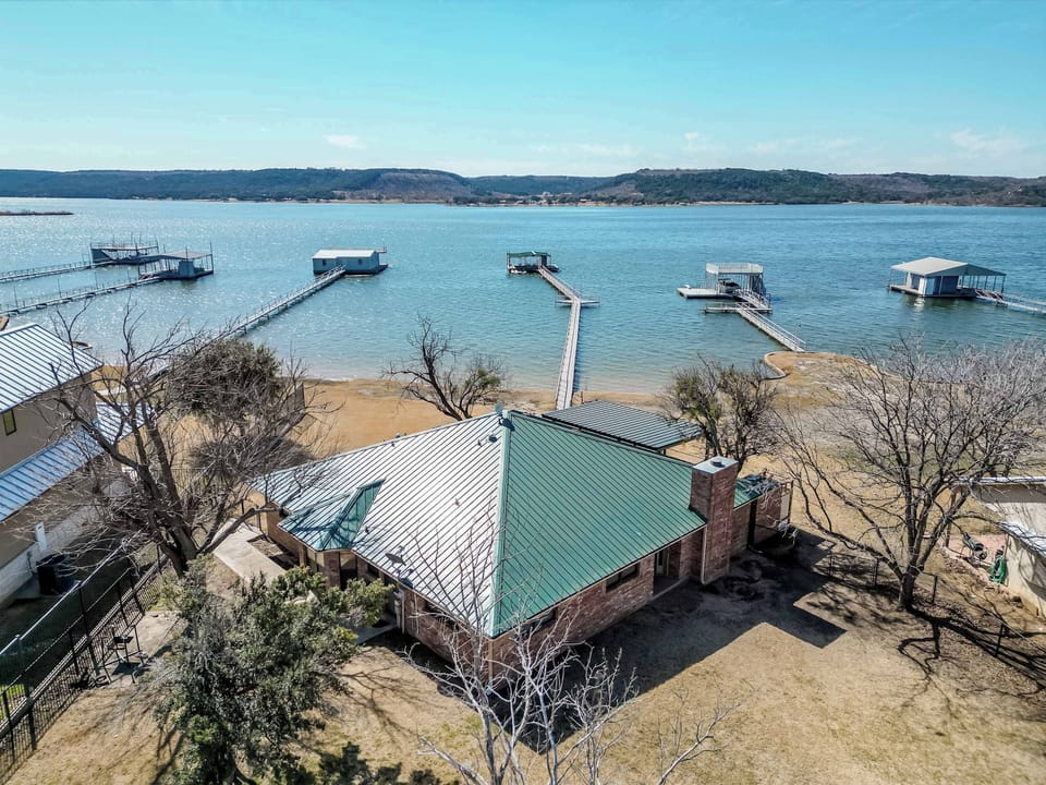 Charming lake house with direct access to Possum Kingdom Lake, featuring private docks and stunning water views. Perfect for a tranquil getaway.