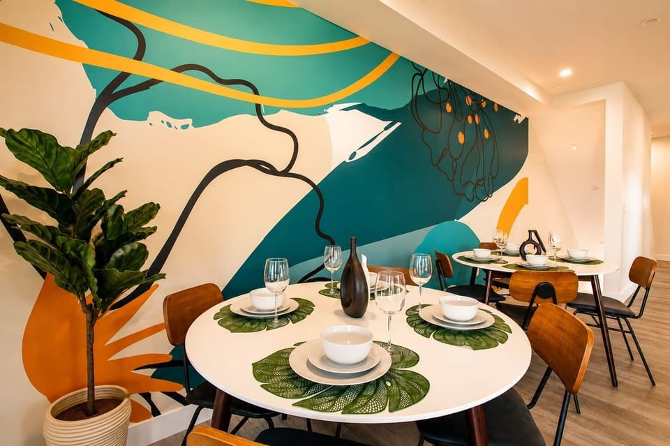 Artistic dining space with bold wall mural and seating