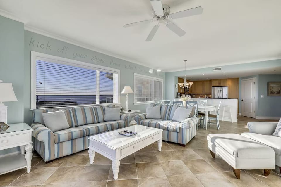 This luxurious family retreat offers a spacious Living Area with plush furniture, perfect for unwinding after a day at the Beach or the Seasonal Rooftop Pool.