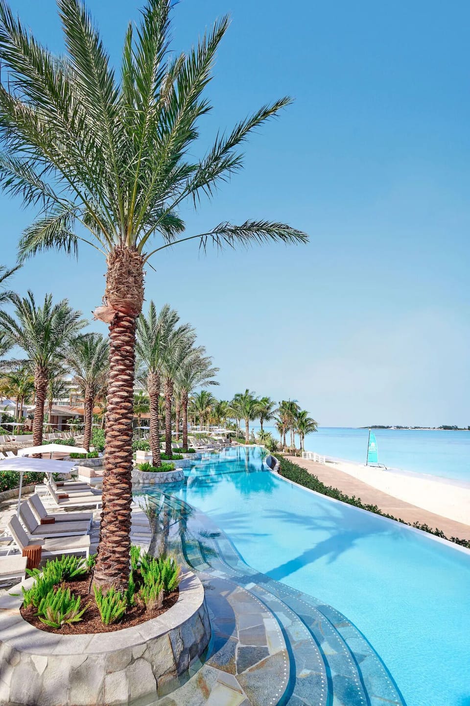 Dive into endless ocean views from the beachfront infinity pool.