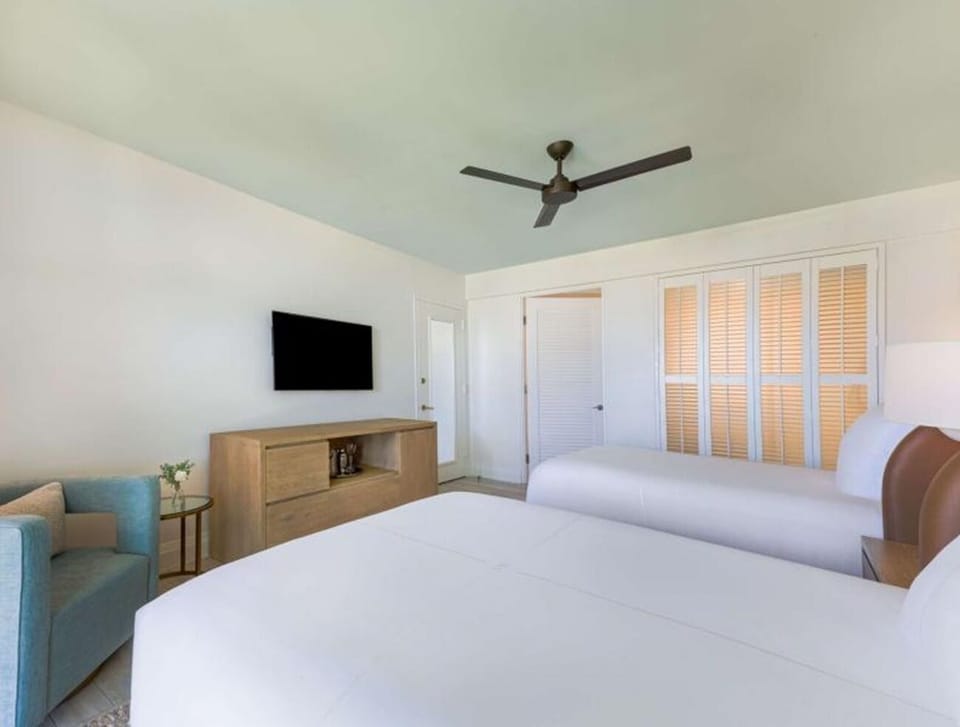 Settle into twin beds with airy, modern island style.