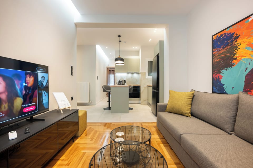 Chic modern lounge with vibrant art and cosy ambience.