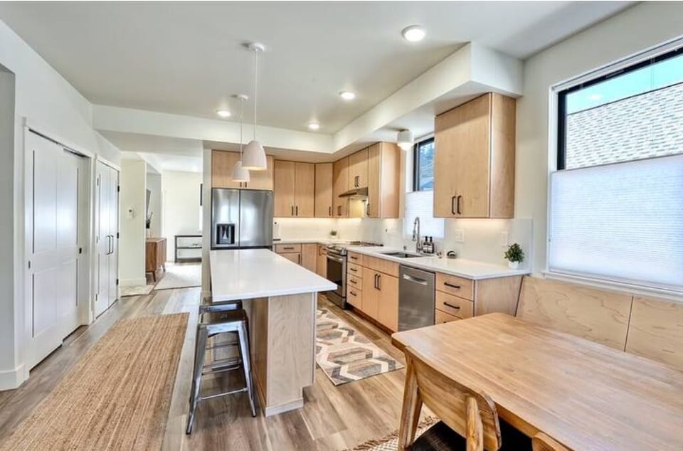 Kitchen viewing from dining area.  Laundry closet behind sliding doors at left.