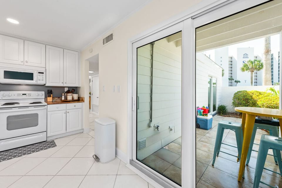 The Seabreeze Villa kitchen is bright and welcoming, featuring crisp white cabinets, marble-inspired countertops, and gold accents. Equipped with modern essentials, including a coffee station to start your mornings right. ☕✨