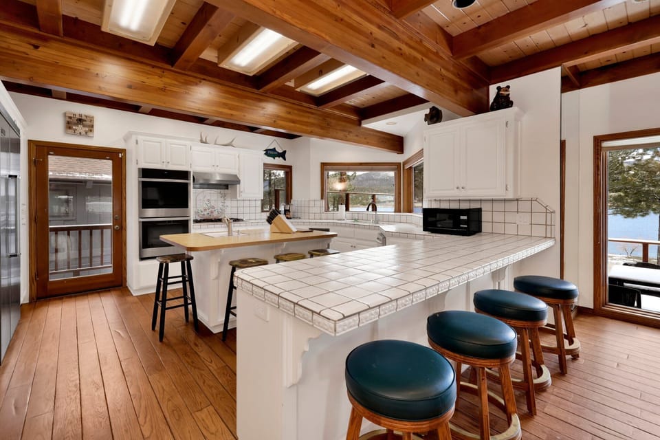 Open kitchen with breakfast bar seating for 4 and island seating for 4