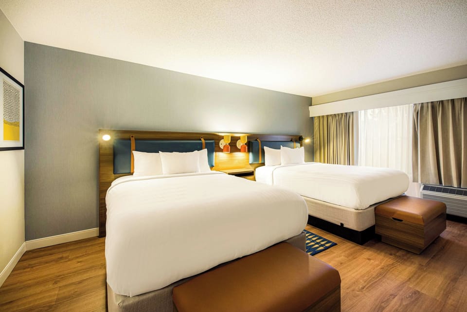 Unwind in crisp linens with spacious two-queen comfort.