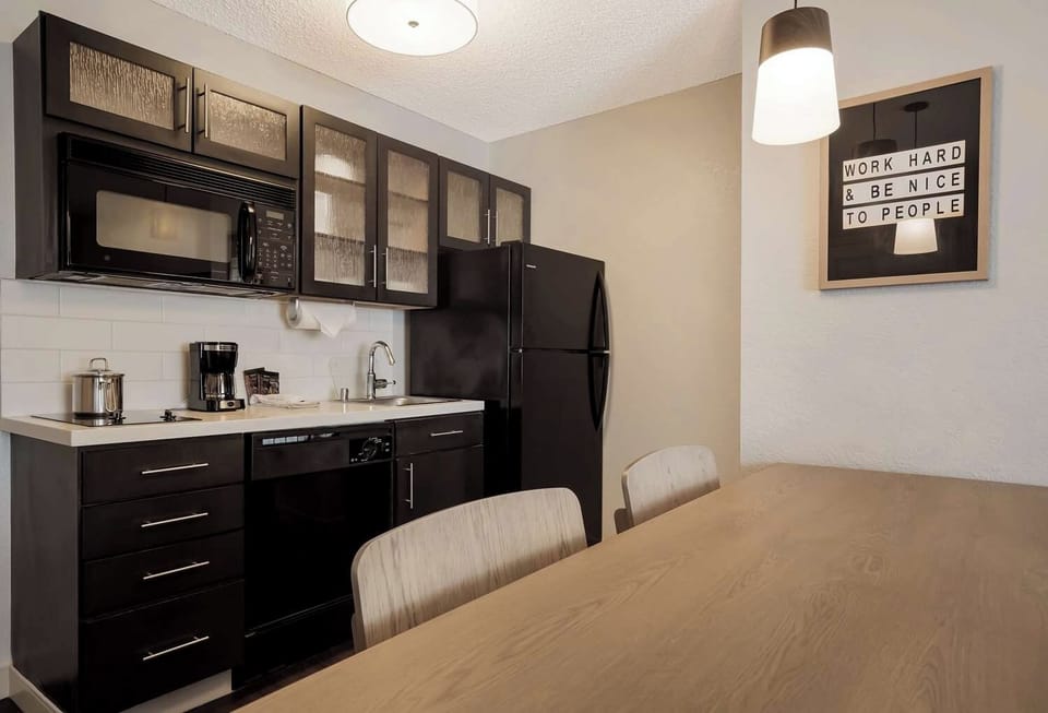 Cook and sip coffee easily in this sleek kitchenette.