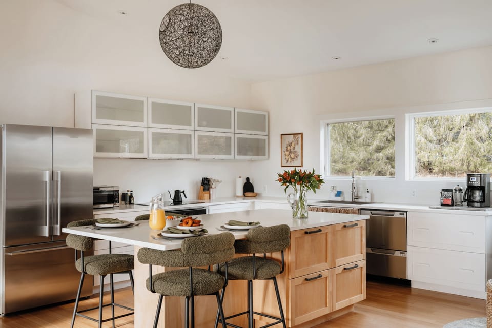 Fully equipped kitchen complete with cookware, dinnerware, and coffee makers.