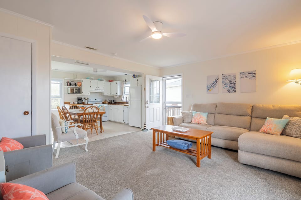 The open living room, kitchen dining area allows your entire family to spend time together and provides water views. 