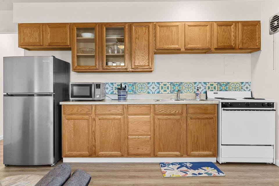 Fridge, microwave, sink, oven, stove, and basic kitchen utensils