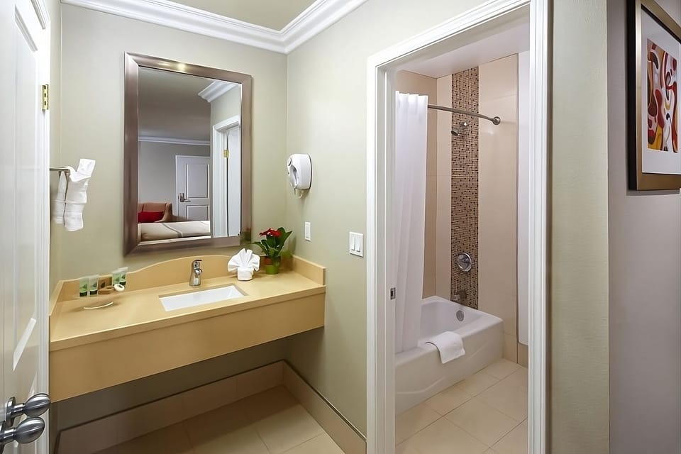 Refresh effortlessly in a spotless bath with bright vanity lighting.
