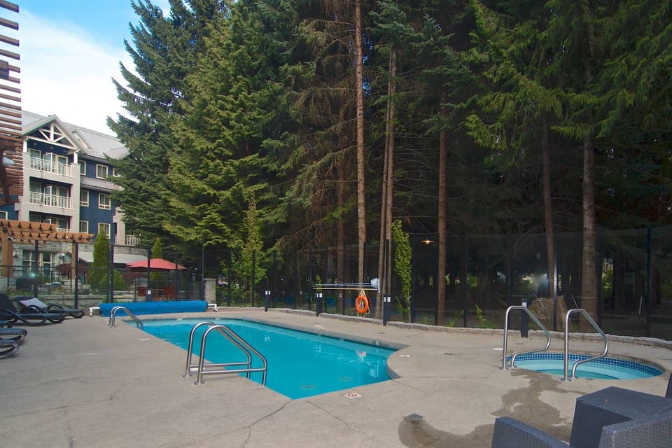 Outdoor heated pool + hot tub with seating area