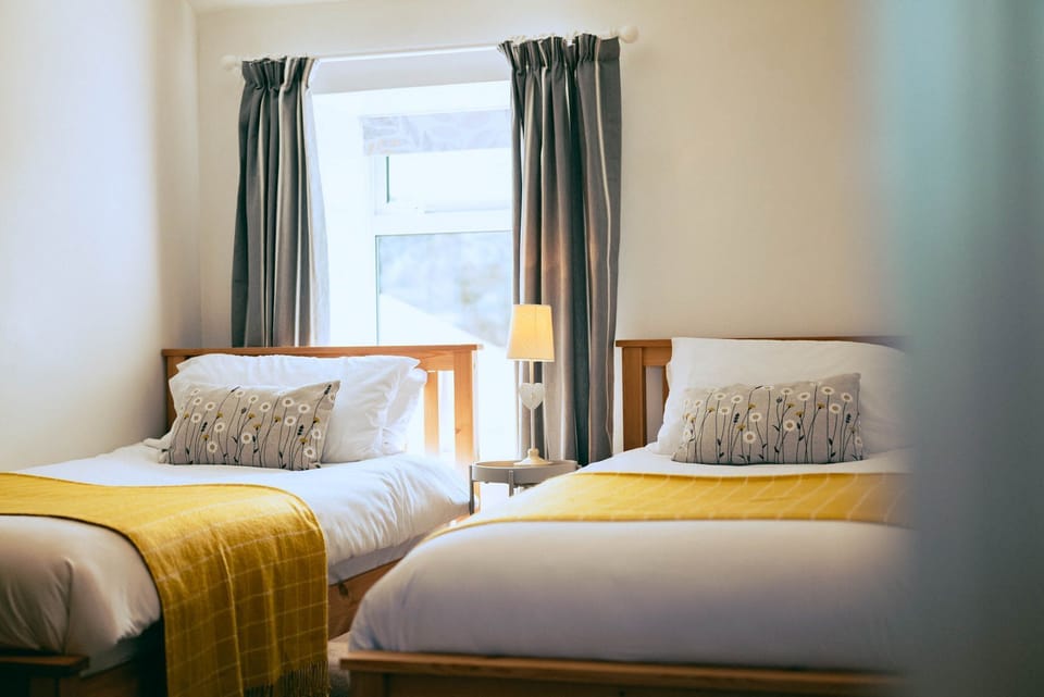 The Granary twin bedroom at Trevalgan Farm Holidays