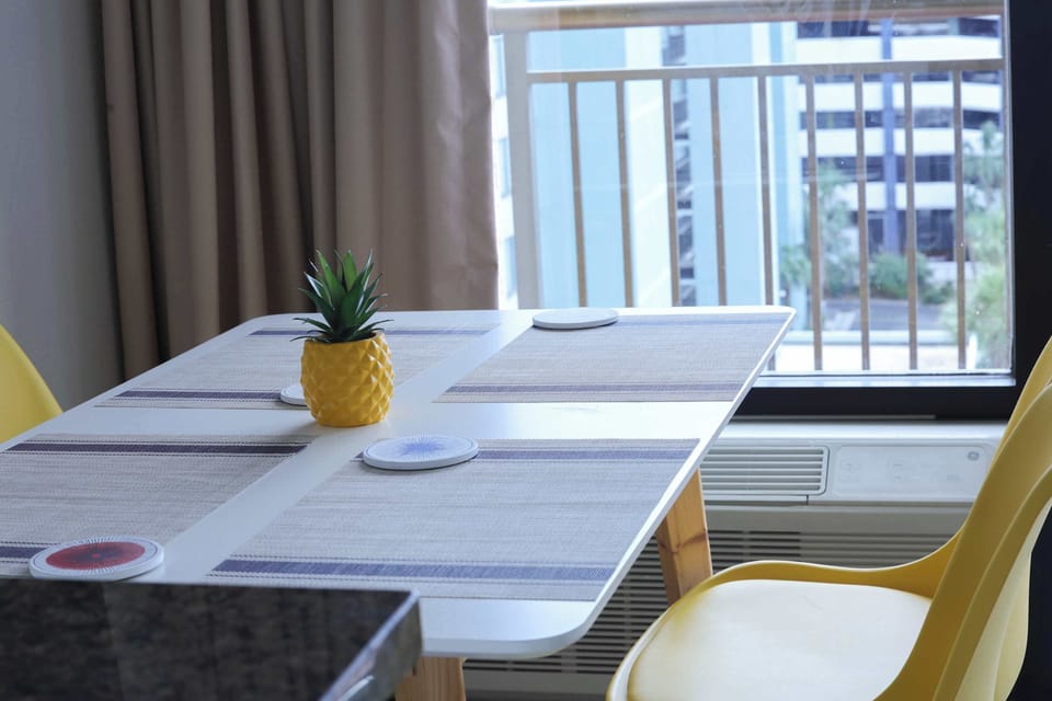 Sunny dining nook with cheerful yellow accents — perfect for morning coffee before the beach. It's breakfast with a view!