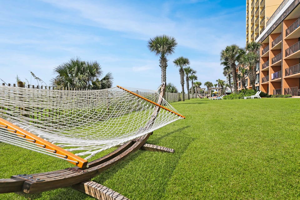 Unwind under the palms on this peaceful oceanfront lawn, where a hammock and sea breeze invite you to relax and soak up the coastal sunshine just steps from your stay.