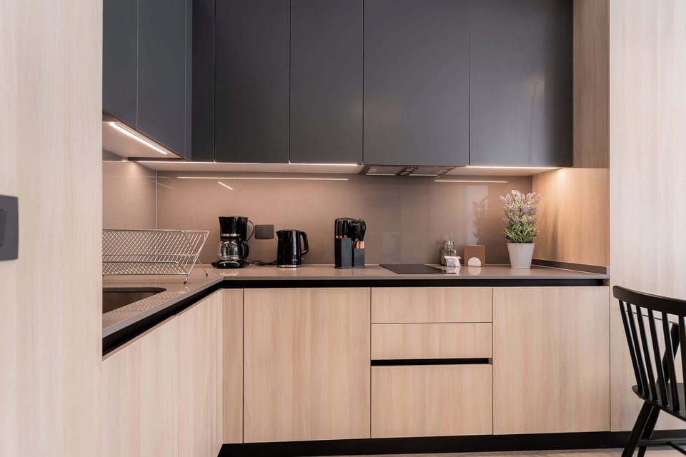 Sleek and modern kitchen with all essentials for your culinary adventures. Enjoy a stylish cooking experience in this well-equipped space.