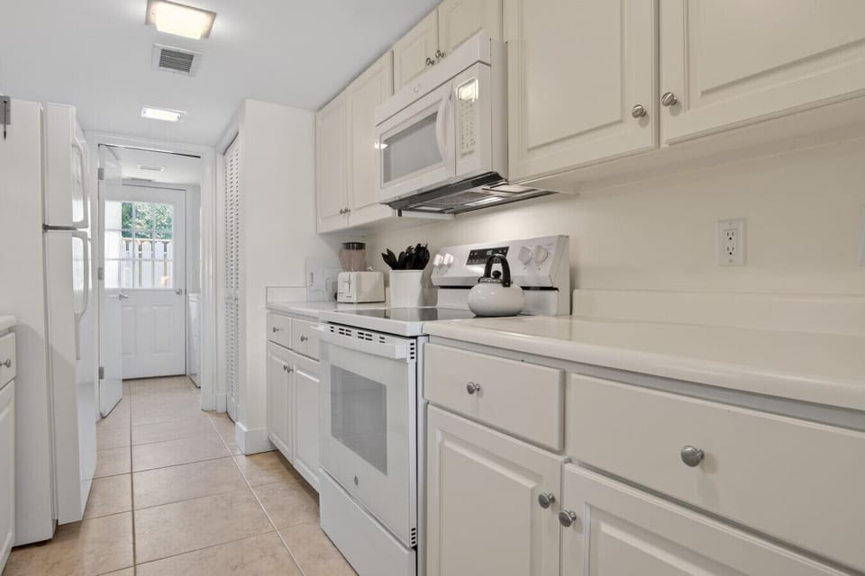 Full kitchen with all mainstay appliances and fully stocked cookware.