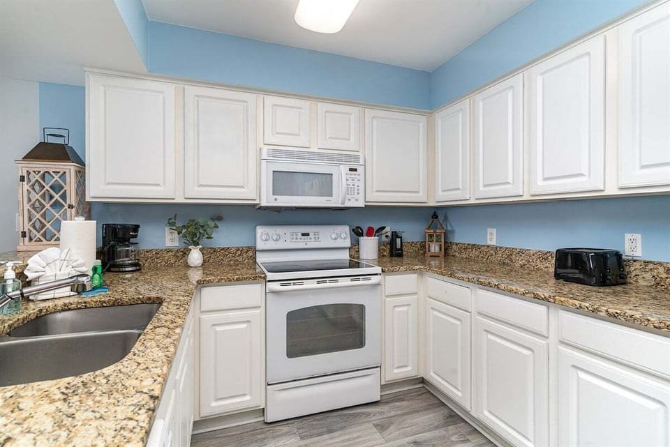 Fully equipped kitchen with ample counter space and everything needed to prepare meals during your stay.