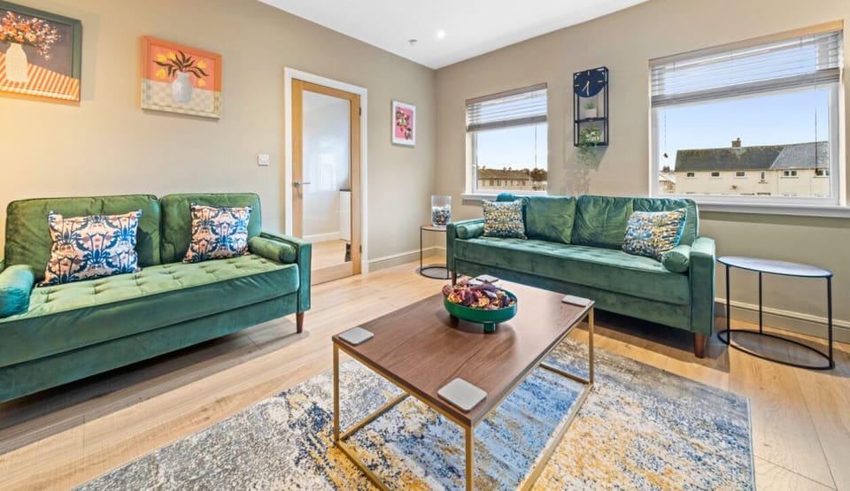 Unwind in style! This beautifully designed living room offers a warm and sophisticated atmosphere, complete with luxurious seating, an ambient fireplace, and a smart TV for your entertainment. The perfect place to relax after a day of exploring!