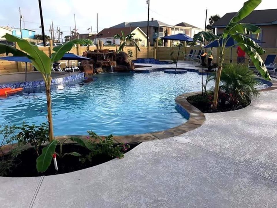 Resort style pool with swim up bar and waterfall. Separate hot tub that seats up to 15.