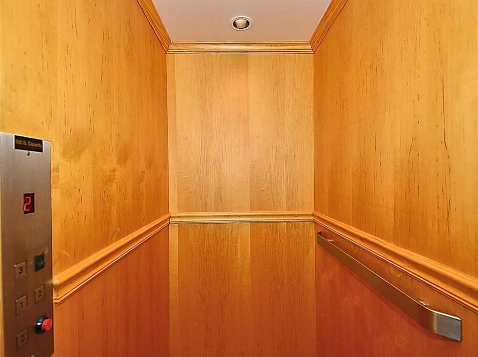 This beautifully appointed elevator features elegant wood paneling—perfect for effortless transitions between the levels of your stunning beach home.