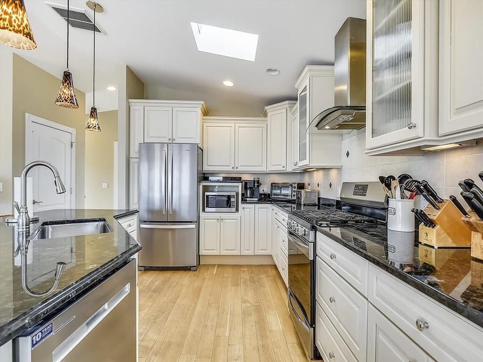 The modern kitchen is equipped with stainless steel appliances and elegant cabinetry, perfect for culinary enthusiasts.