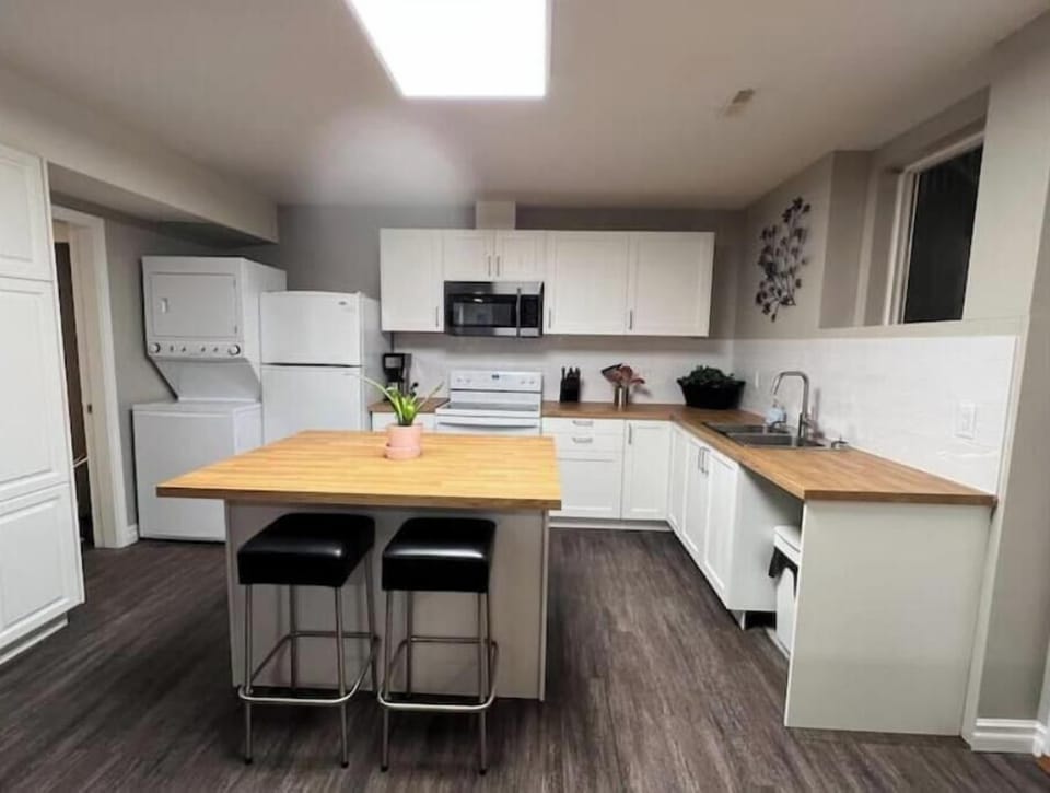 Newly renovated kitchen with W/D, cooking range, microwave, and dishwasher