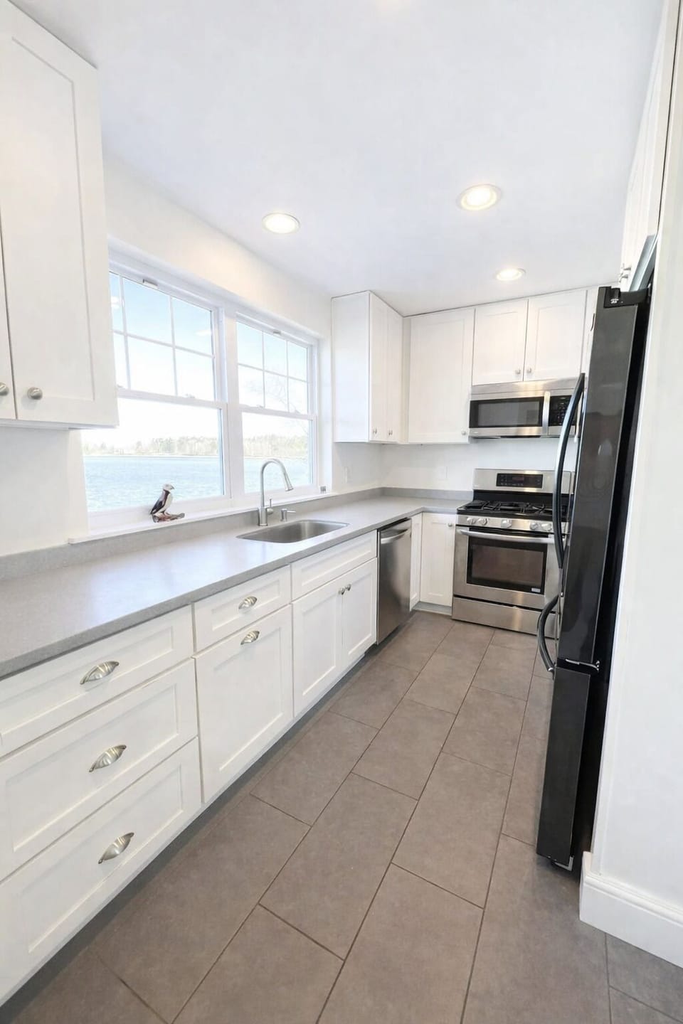 The newly updated galley style kitchen comes with breathtaking views of the cove.