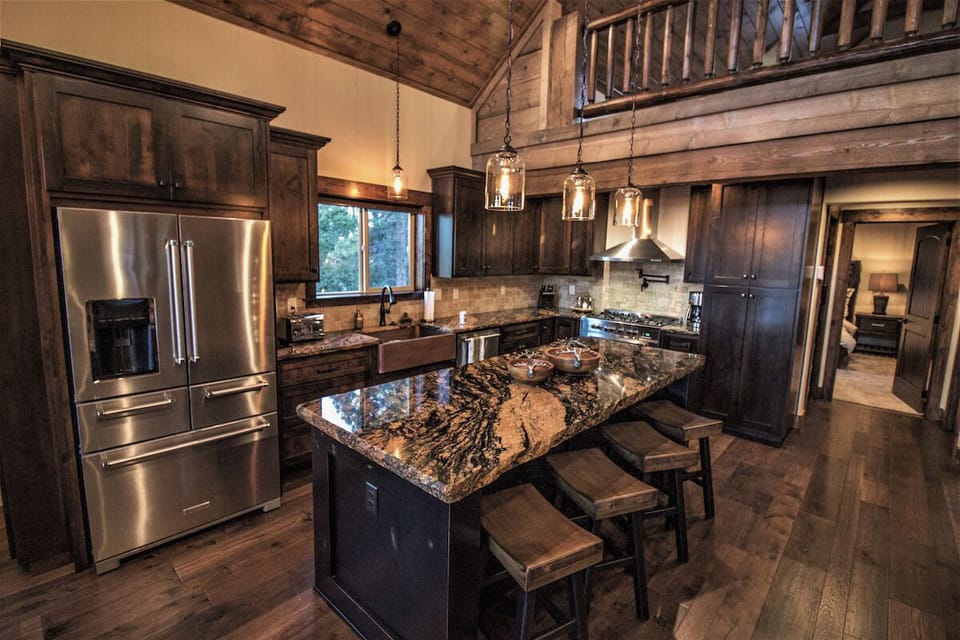Spacious kitchen with island seating and vaulted wood ceilings
