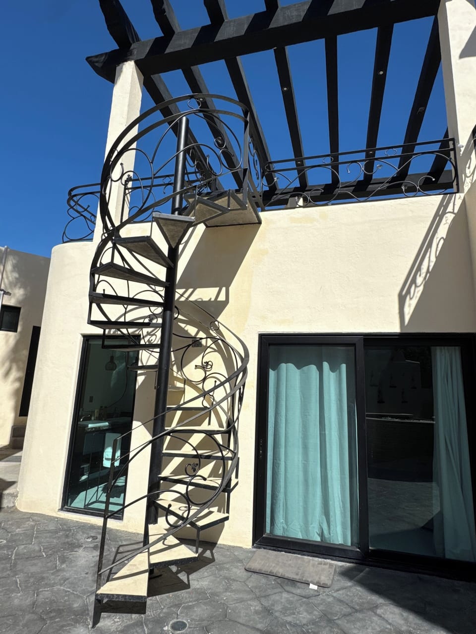 spiral staircase leads down to backyard pool deck from all 4 upstiars bedrooms