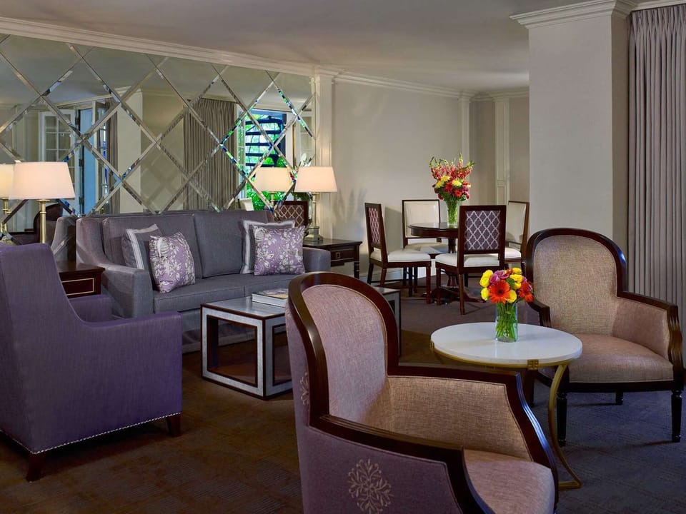 Unwind in the stylish lounge with soft seating and blooms.