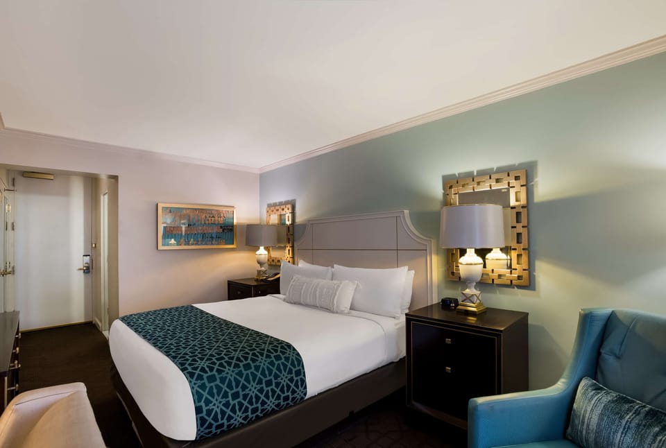 Relax into crisp linens and calming tones after a busy day.