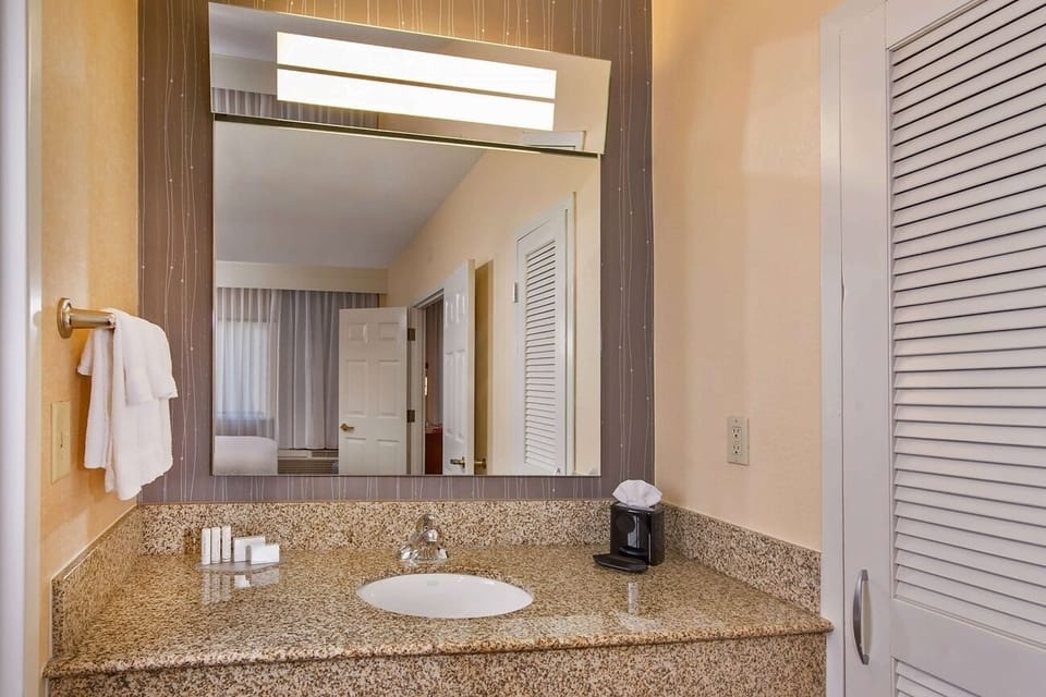 Refresh at a wide vanity with bright, flattering lighting.
