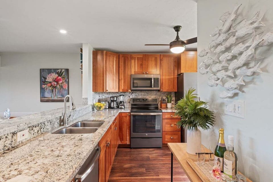 Gourmet kitchen with granite countertops, stainless steel appliances, and bar seating—perfect for cooking and casual dining.