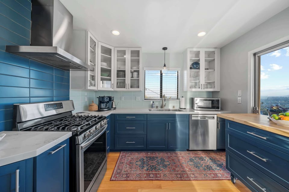 Kitchen | Prussian Blue and White Cabinetry Kitchen | Light Turquoise Backsplash