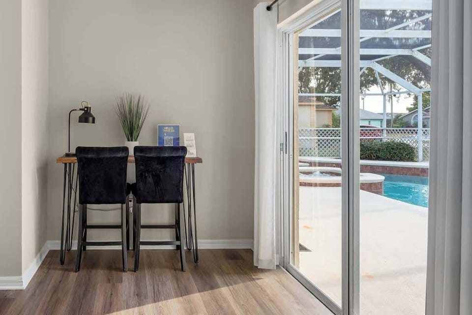 A spacious kitchen with modern appliances, and a beautiful view of the pool.