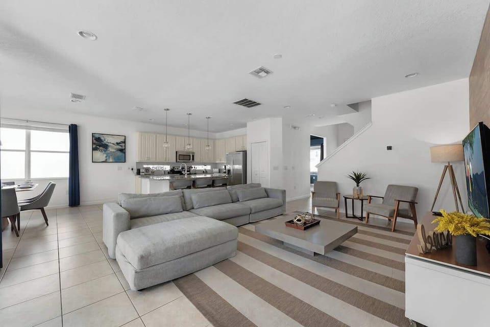 An open concept living room with charming and modern decoration.