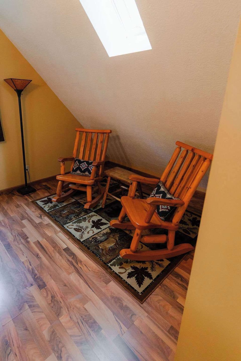 Sitting Room: Unwind in rustic rocking chairs under skylights with charming decor!