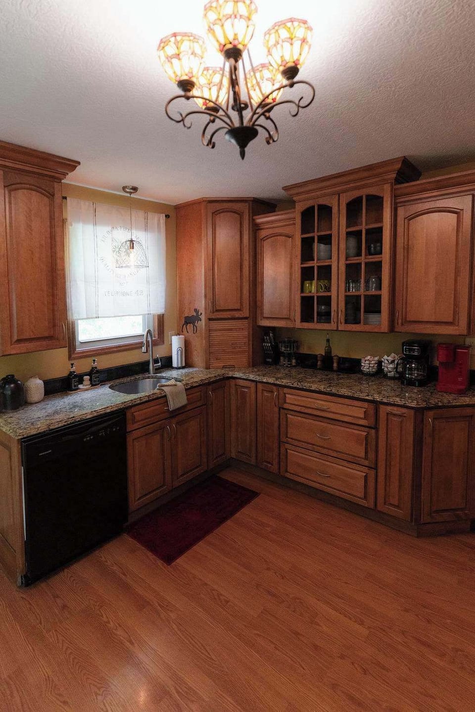 Kitchen: Culinary adventures await in this elegant space with rich cabinetry and modern amenities!