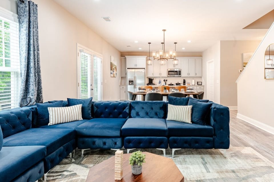 Plush seating & designer accents: Sink into the oversized velvet sofa, complete with custom-patterned accent pillows for a refined yet cozy touch.