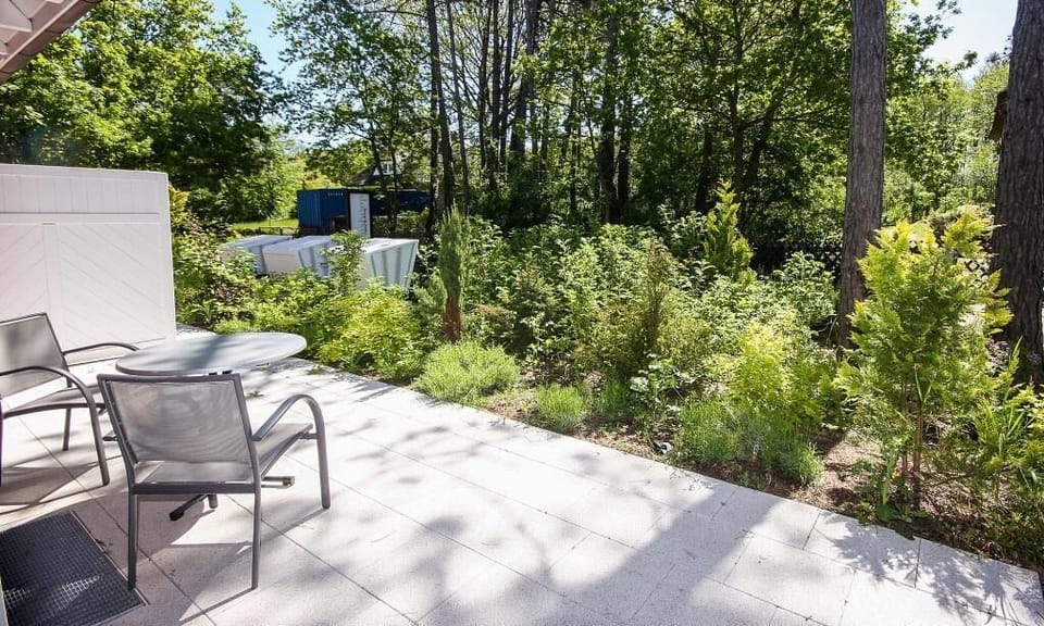 Terrace overlooking adjacent green plants.