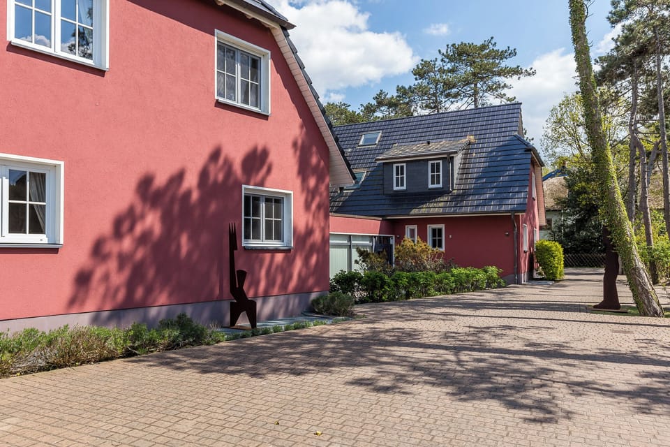 Exterior view of the red building with garden