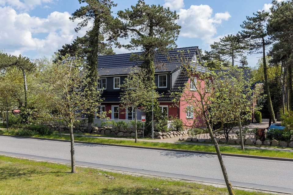 Exterior view of a modern house with red facade