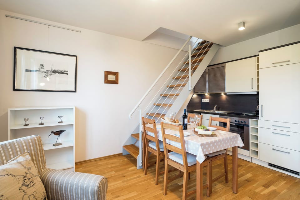 Modern Kitchen with Dining Table and Staircase